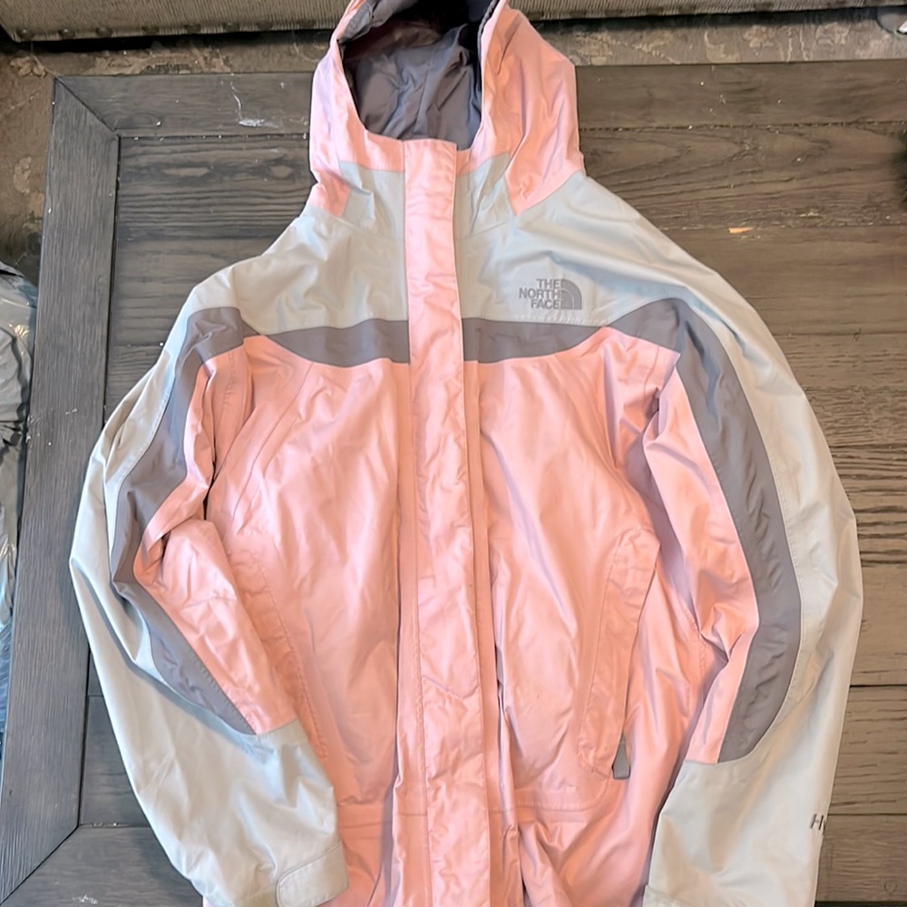 The North Face girl’s size L rain coat in pink and grey